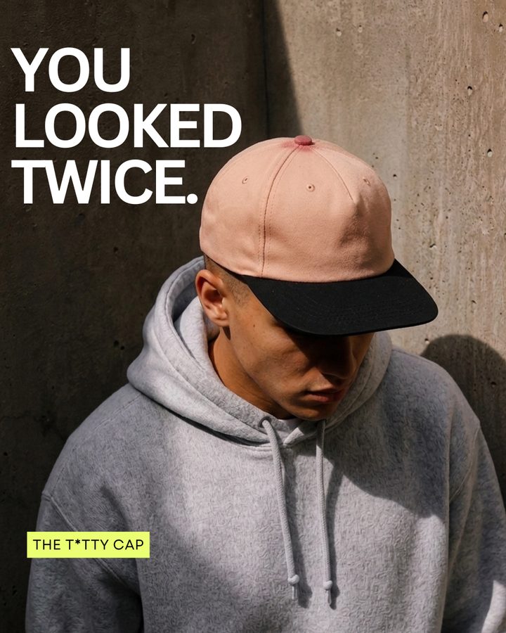 Static ad: a man in a grey hoodie wearing the Titty Cap, headline 'You looked twice.'